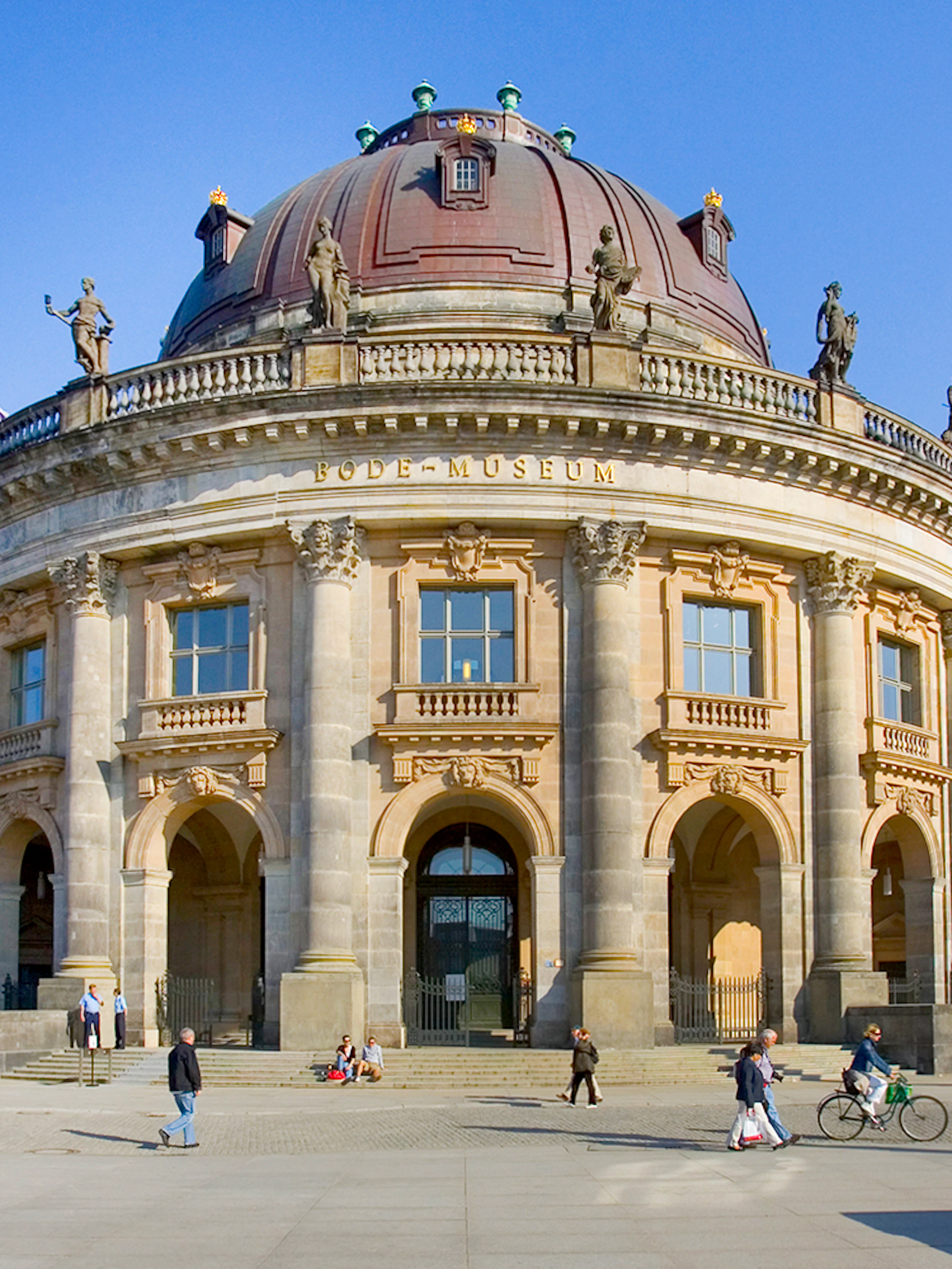 Bode Museum in Berlin with visitors walking and cycling nearby.