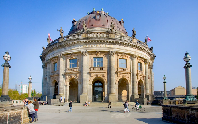 Bode Museum in Berlin with visitors walking and cycling nearby.