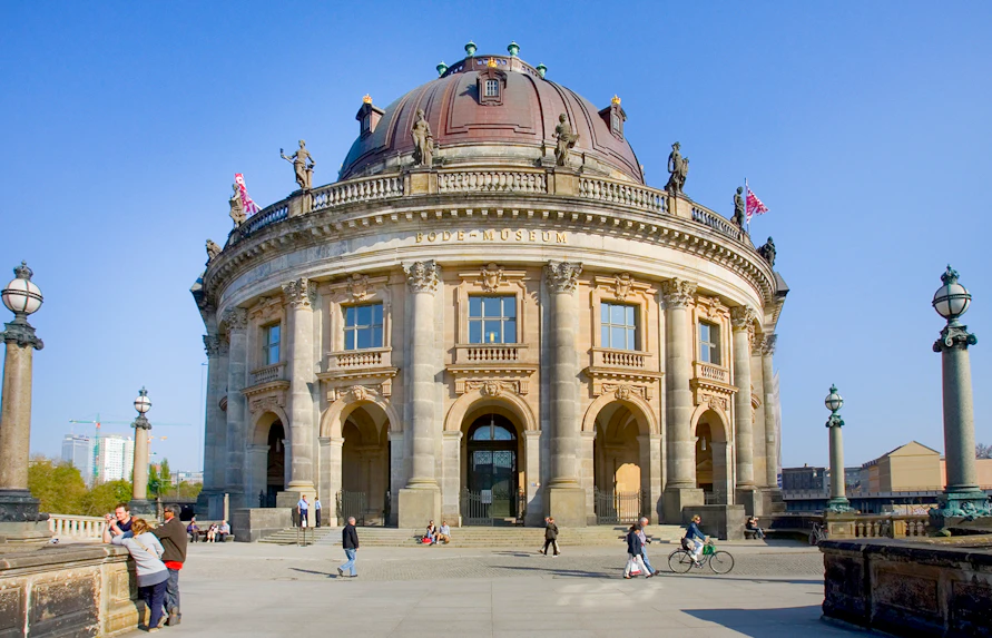 Bode Museum in Berlin with visitors walking and cycling nearby.