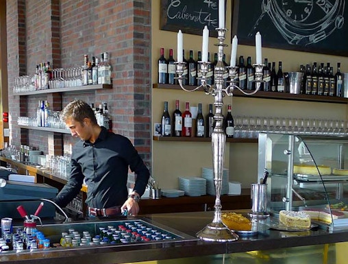 Bar area at Panoramapunkt Berlin with bartender preparing drinks.