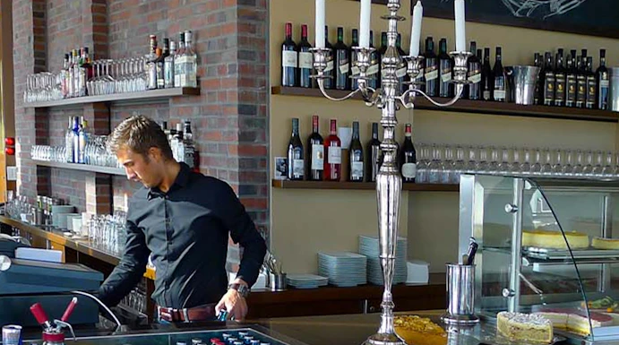 Bar area at Panoramapunkt Berlin with bartender preparing drinks.