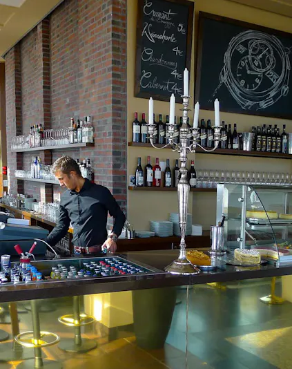 Bar area at Panoramapunkt Berlin with bartender preparing drinks.