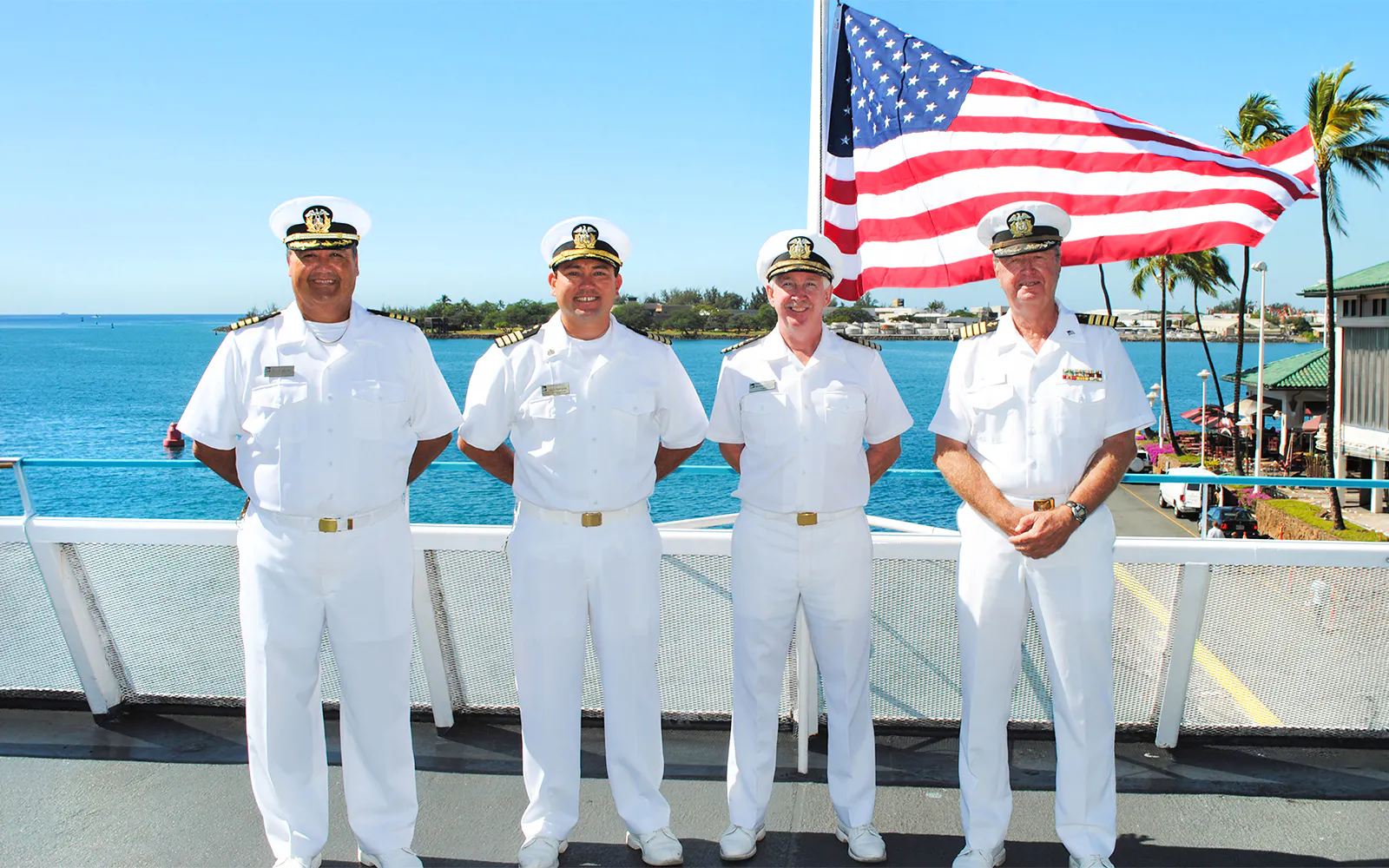 Crew members on deck with American flag, Star Independence Day Cruise, Hawaii.