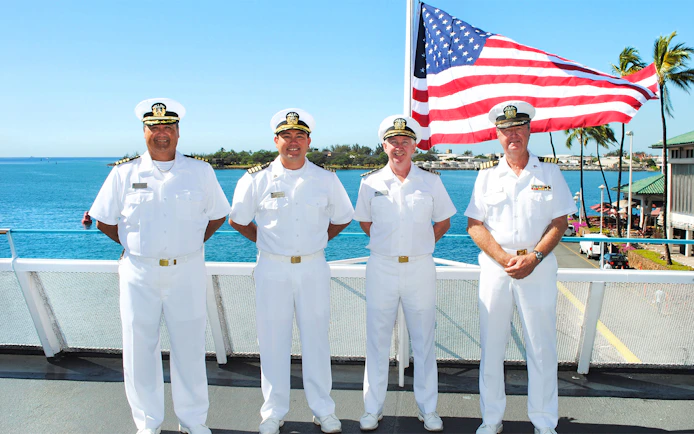 Crew members on deck with American flag, Star Independence Day Cruise, Hawaii.