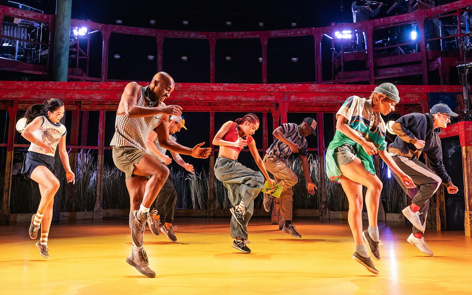 Dancers performing energetically on stage in Illinois theater show.
