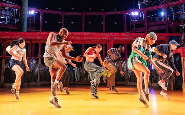 Dancers performing energetically on stage in Illinois theater show.