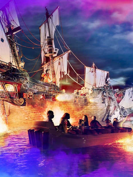 Boat ride near pirate ship at Disneyland Paris attraction.