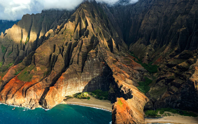 Na Pali Coast cliffs and beach on Kauai from above.