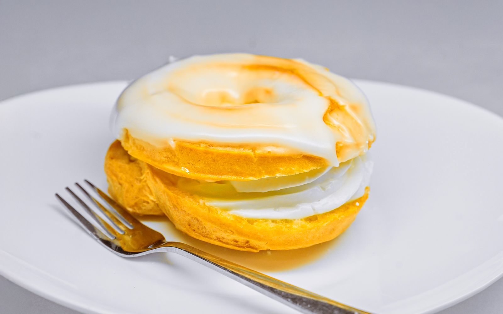 Traditional Czech "Větrník" Pastry with White Sugar Glaze on a Plate