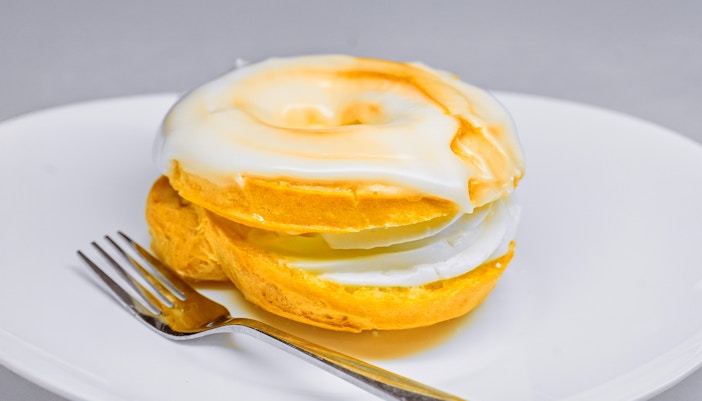 Traditional Czech "Větrník" Pastry with White Sugar Glaze on a Plate