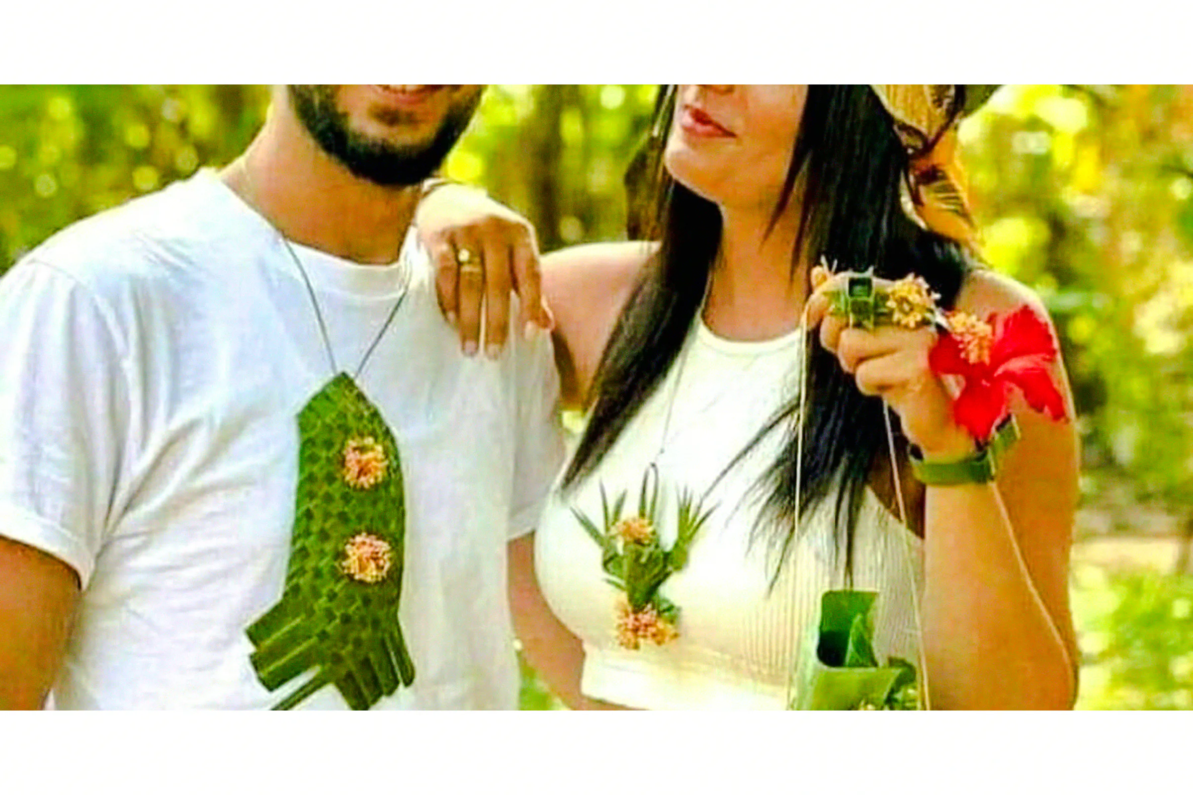 Couple wearing handmade leaf and flower accessories at a Zanzibar spice farm.
