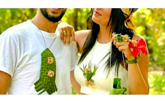 Couple wearing handmade leaf and flower accessories at a Zanzibar spice farm.