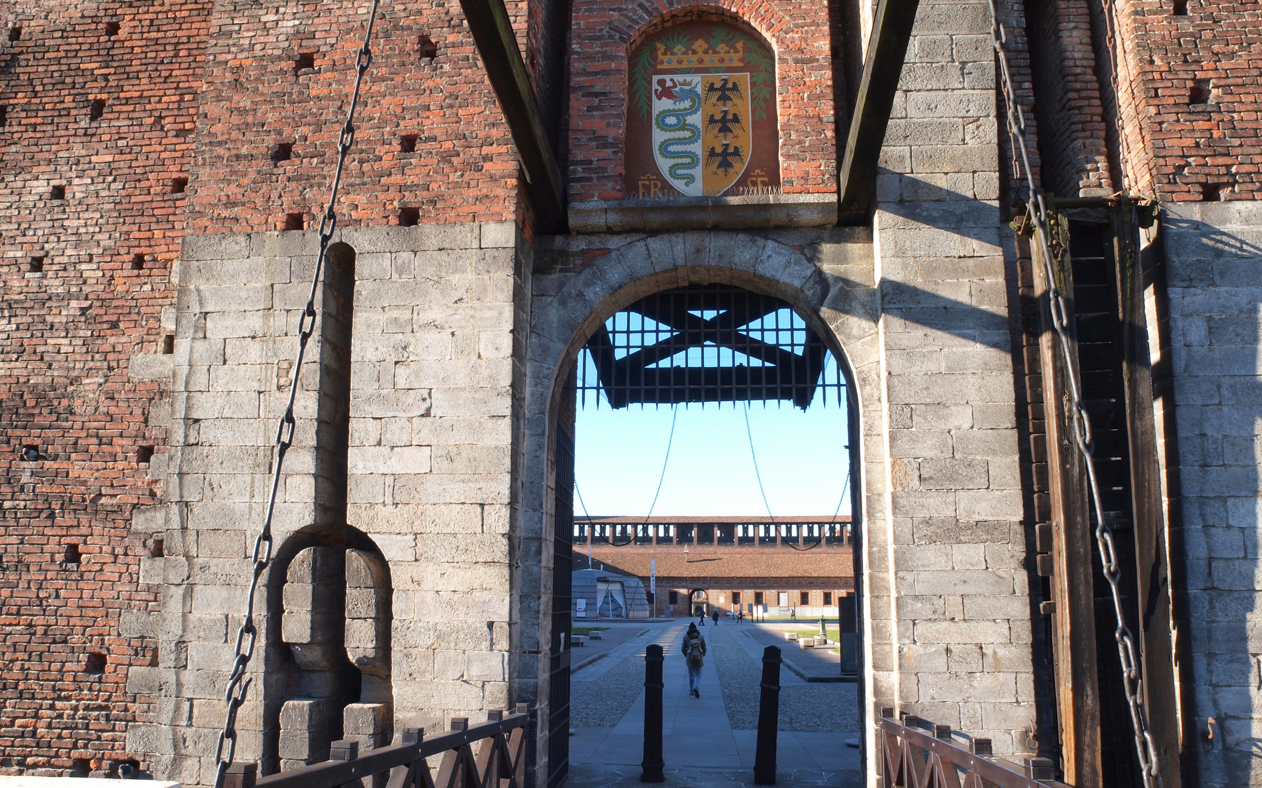 Entrance gate of Sforza Castle in Milan with view of the courtyard.