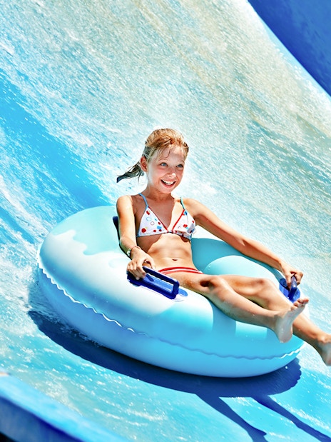 Child enjoying a water slide at Ramayana Water Park.