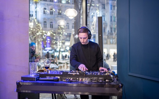 DJ performing at Czech tapas cuisine tasting tour with drinks in Prague.