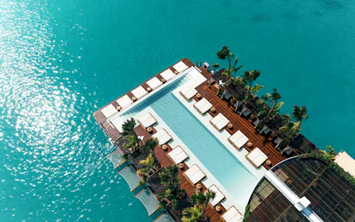 Aerial view of Yona Beach Club's pool and lounge area in Phuket.