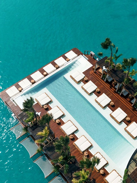 Aerial view of Yona Beach Club's pool and lounge area in Phuket.
