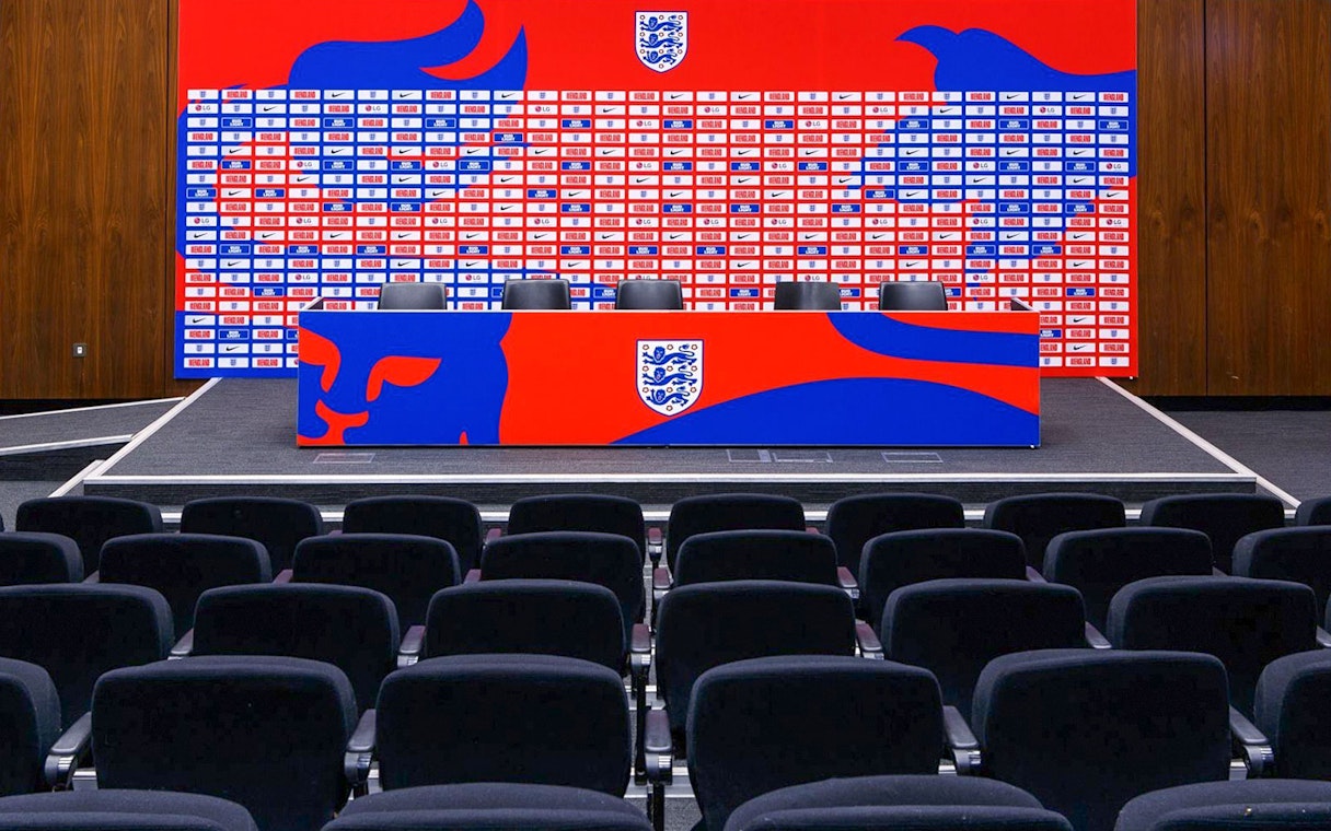 Press conference area with seating and backdrop at Wembley Stadium.