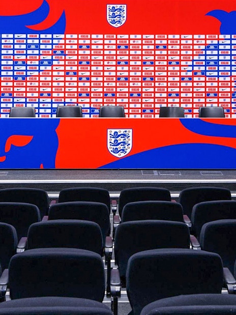 Press conference area with seating and backdrop at Wembley Stadium.