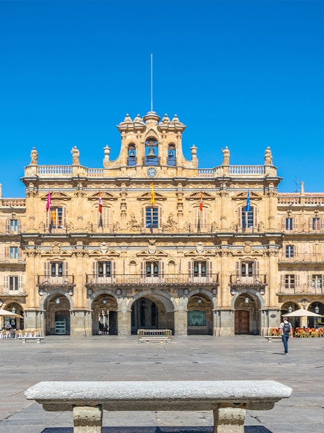 Tourists walking in Plaza Mayor, Salamanca, Spain, with historic architecture in the background.