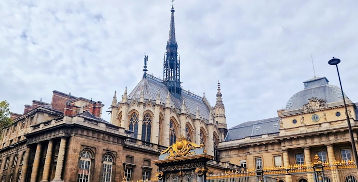 Sainte-Chapelle exterior with ornate spire and golden gate in Paris, France.