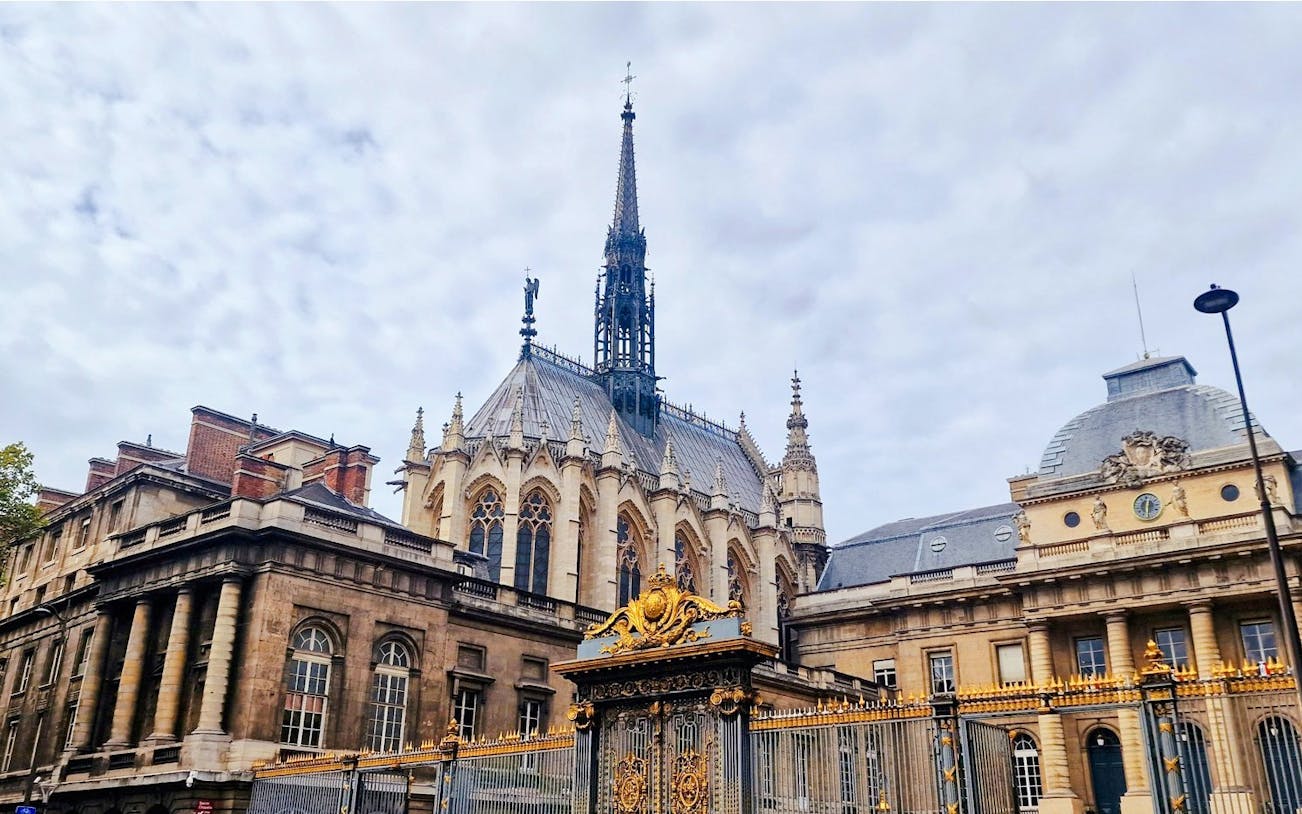 Sainte-Chapelle exterior with ornate spire and golden gate in Paris, France.