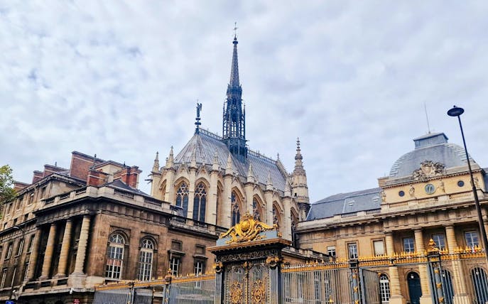 Sainte-Chapelle exterior with ornate spire and golden gate in Paris, France.
