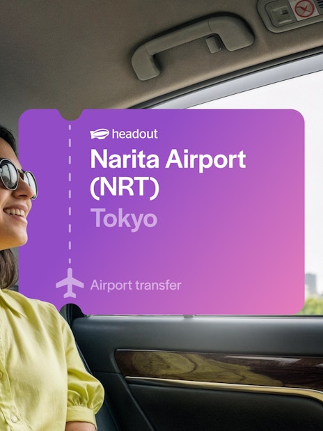 Woman in car viewing Tokyo Tower through window, Tokyo.