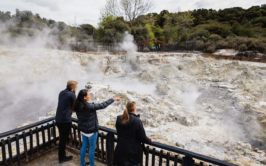 Tourists observing geothermal steam at Hells Gate Geothermal Walk.
