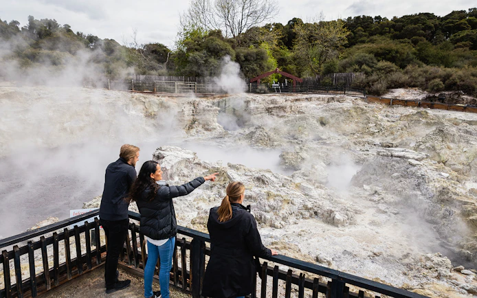 Tourists observing geothermal steam at Hells Gate Geothermal Walk.