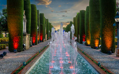 Fountain illuminated at night in the Alcazar of Cordoba garden, Spain.