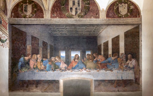 The Last Supper painting in Santa Maria delle Grazie, Milan, Italy, with Sforza Castle in the background.