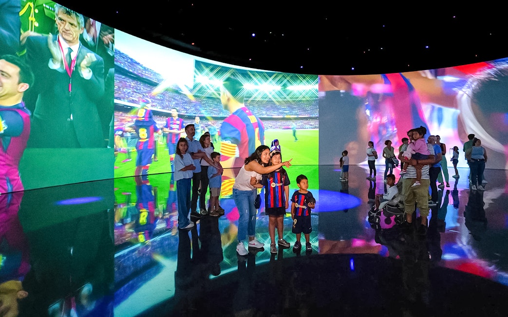 Visitors exploring interactive displays at the Spotify Camp Nou Barça Museum.