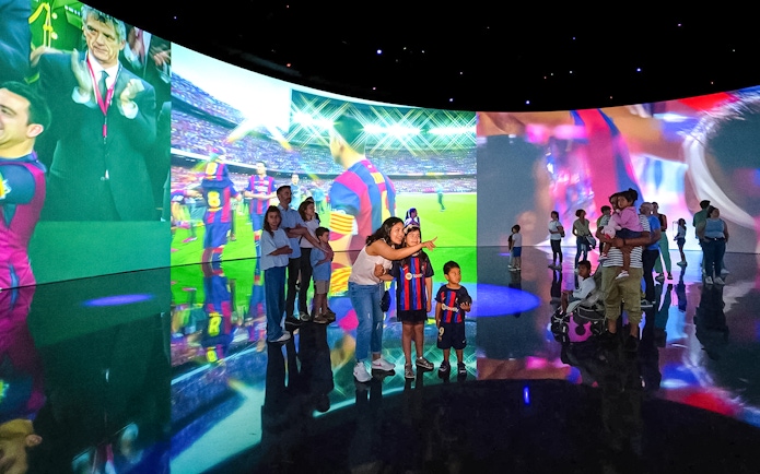 Visitors exploring interactive displays at the Spotify Camp Nou Barça Museum.