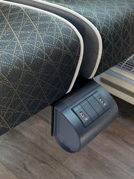 USB charging ports under a seat on the SIT shuttle bus from Fiumicino Airport to Rome city center.