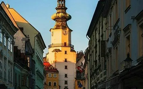 Bratislava's Michael's Gate at sunset during self-guided city exploration game.