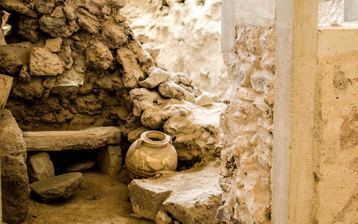 Ancient pottery and stone walls at Akrotiri Archaeological Site, Santorini.