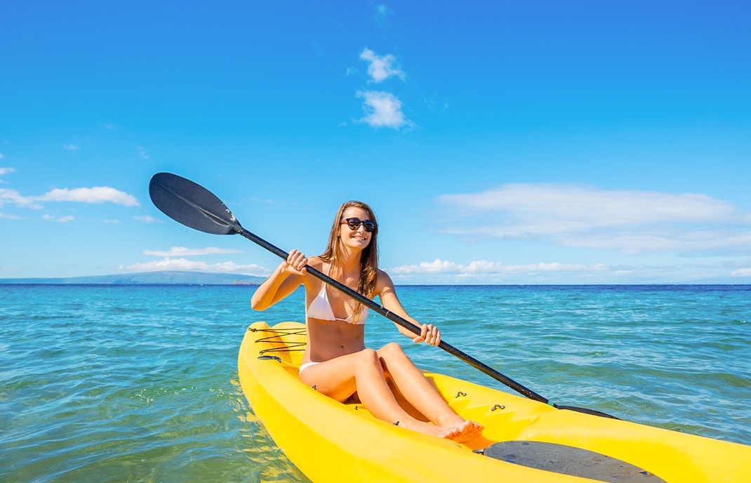 Woman kayaking near Moreton Island shipwreck, Brisbane, Australia.