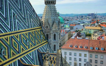 St. Stephen's Cathedral roof and Vienna cityscape, part of a self-guided exploration game.