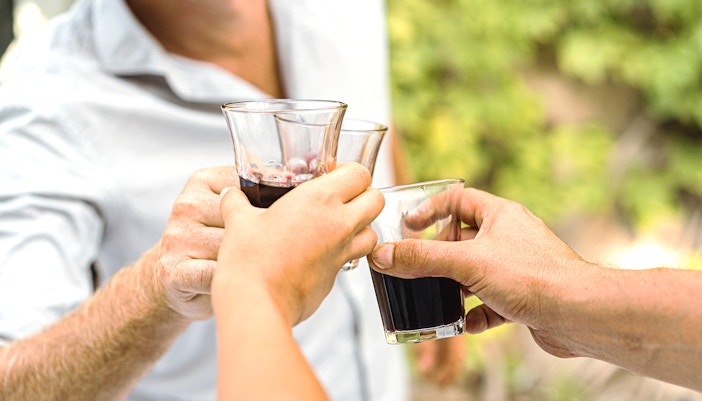 Mount Etna vineyard with wine barrels and scenic Sicilian landscape.