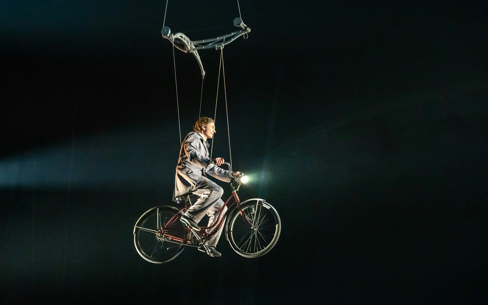 Performer on suspended bicycle at Cirque du Soleil: Corteo show.