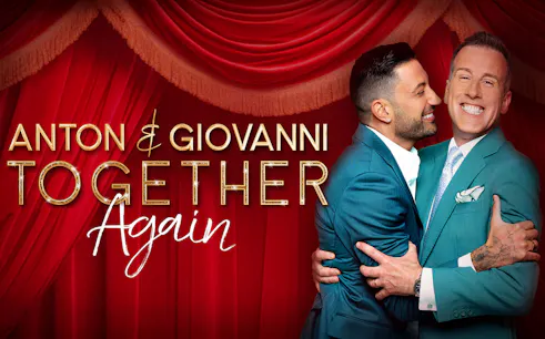 Anton and Giovanni embracing in front of red stage curtains for "Together Again" show.