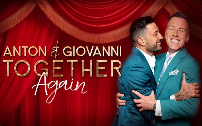 Anton and Giovanni embracing in front of red stage curtains for "Together Again" show.