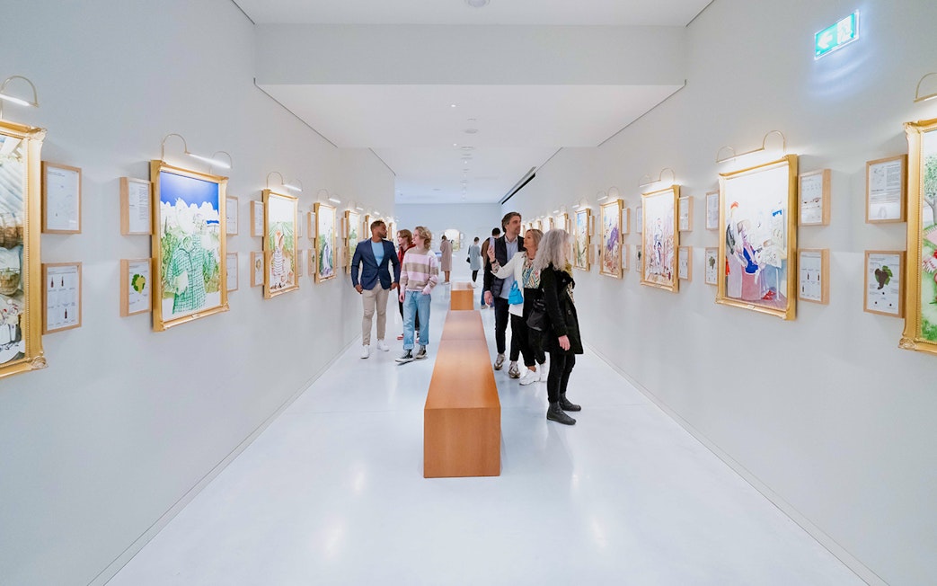 Visitors exploring art gallery at The Wine Experience.