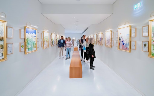 Visitors exploring art gallery at The Wine Experience.