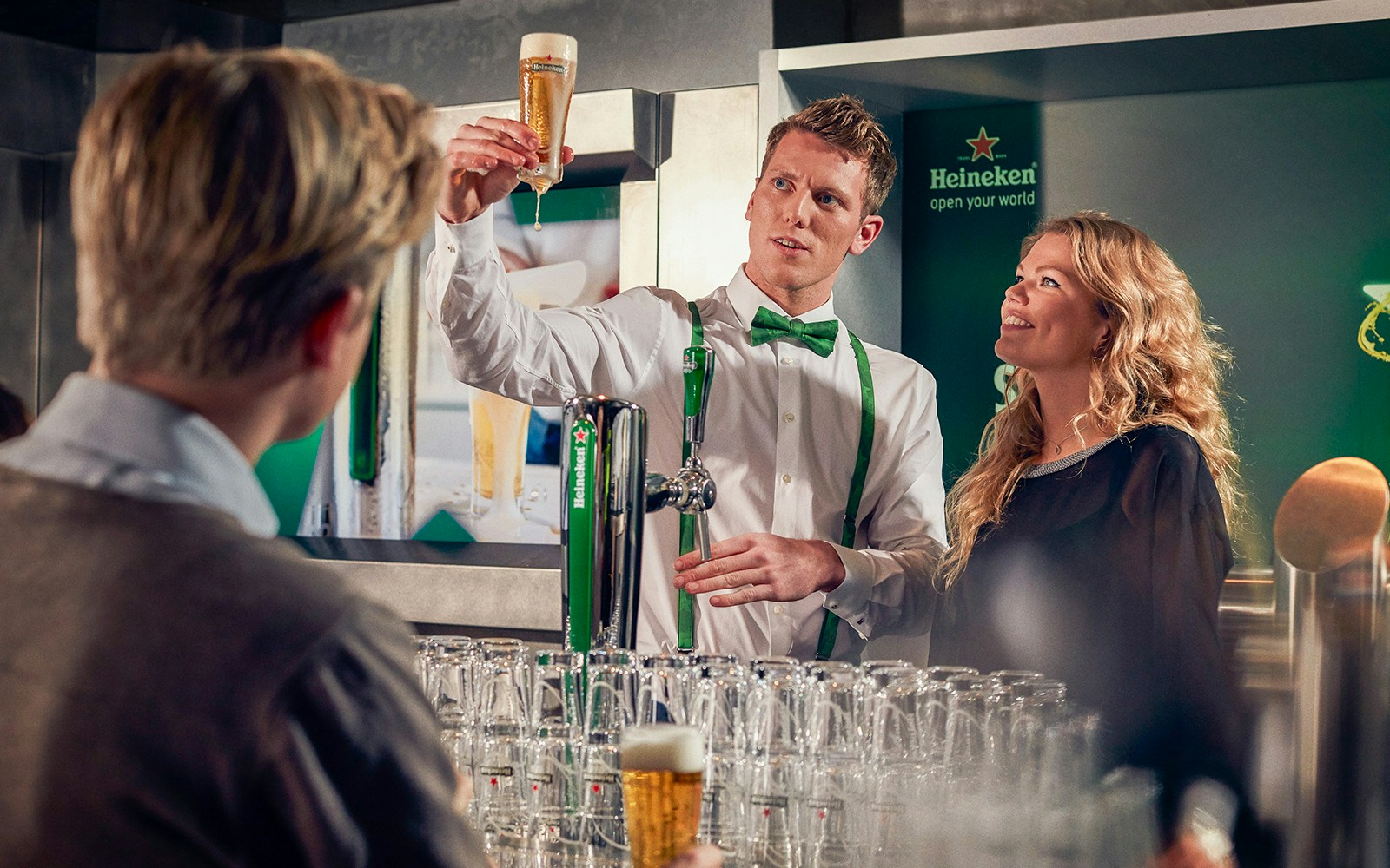 Heineken brewery guide showing beer to visitors inside the brewery.