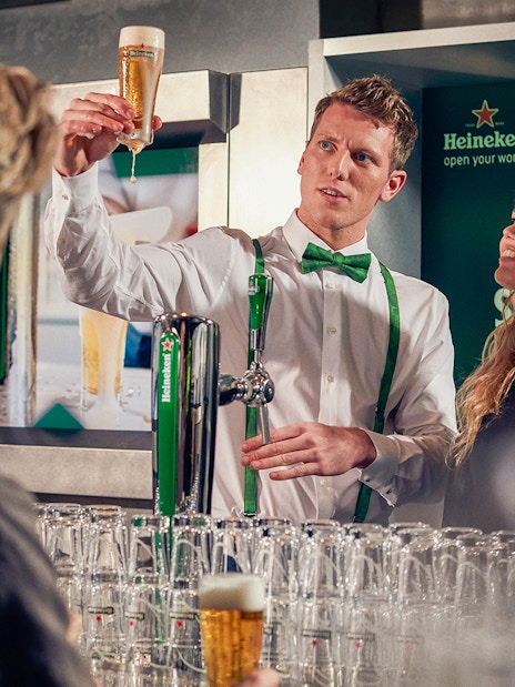 Heineken brewery guide showing beer to visitors inside the brewery.