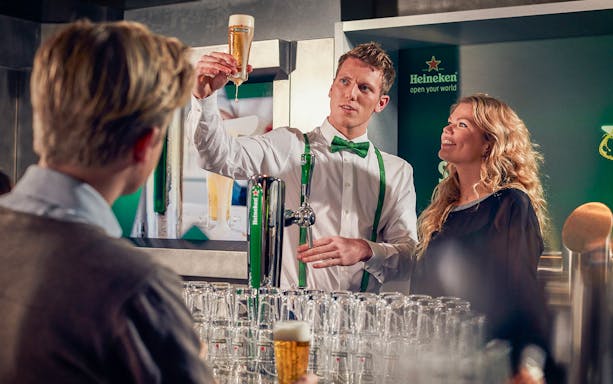 Heineken brewery guide showing beer to visitors inside the brewery.