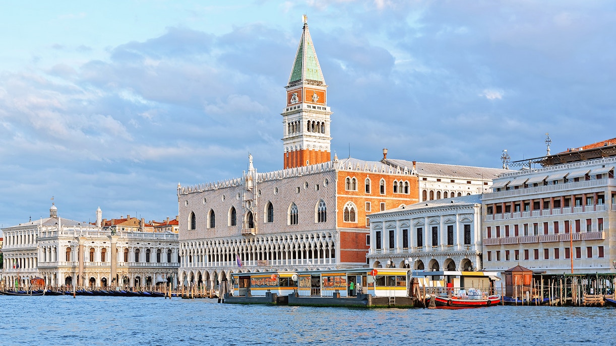St. Mark's Bell Tower in Venice with tourists in the foreground.