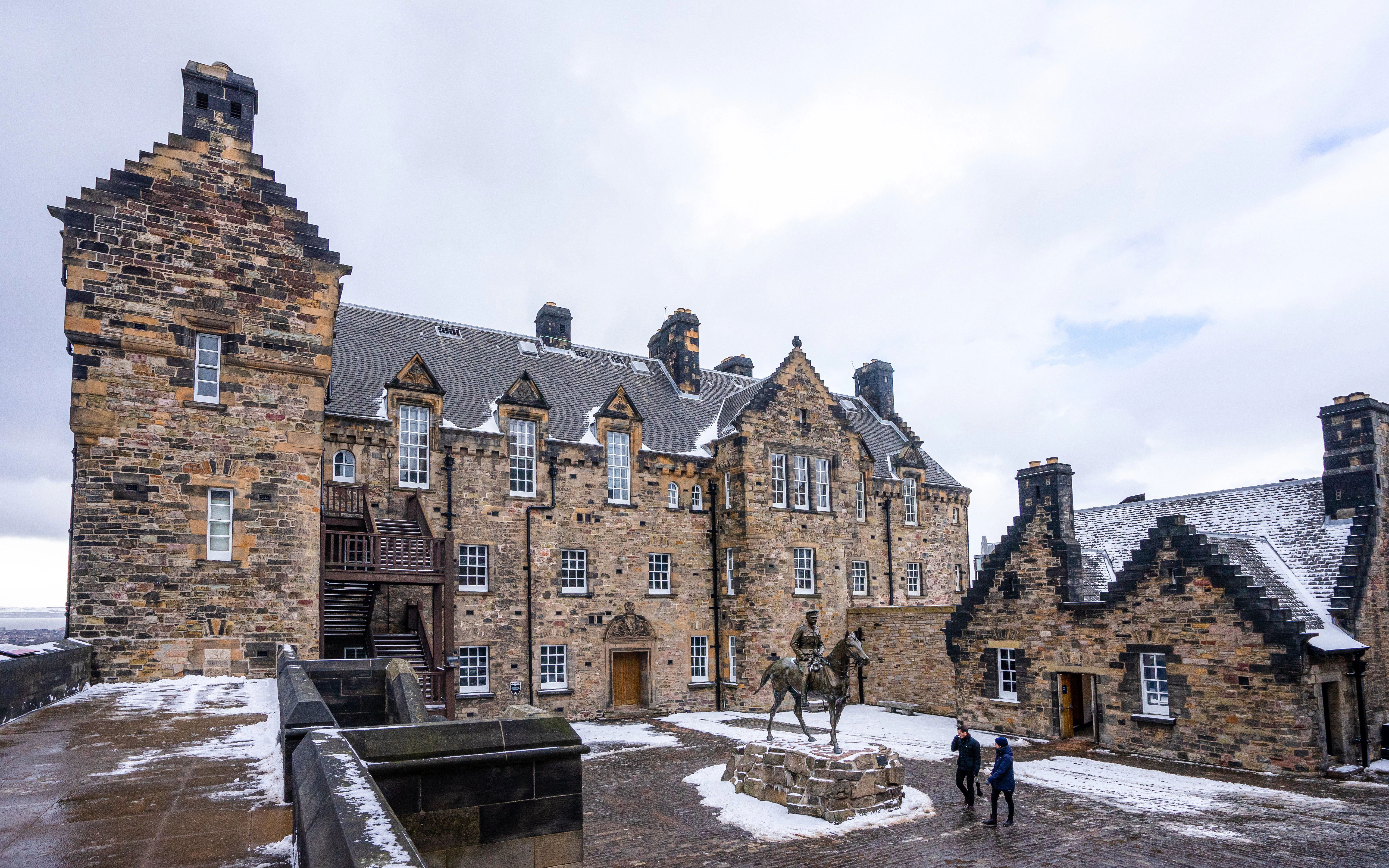 Edinburgh Castle courtyard with statue and snow, Scotland winter morning.